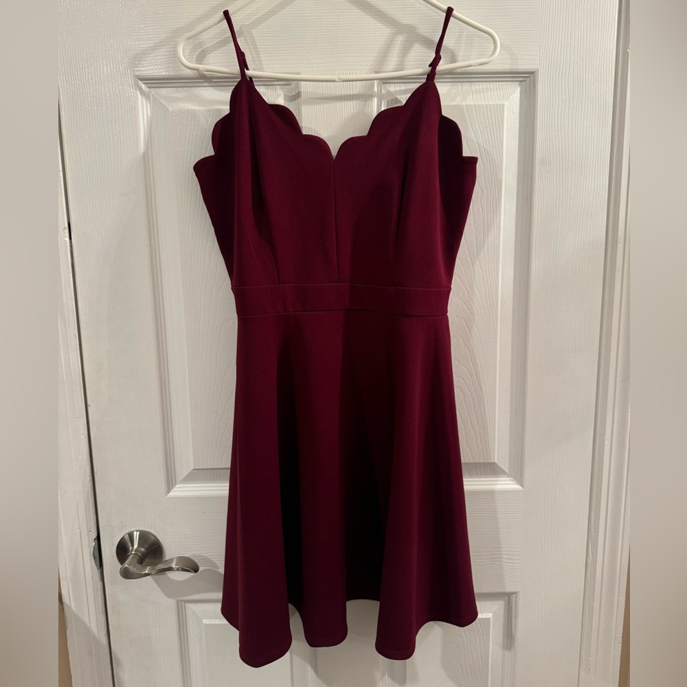 Women’s B. Darlin burgundy red mini dress with scalloped neckline.